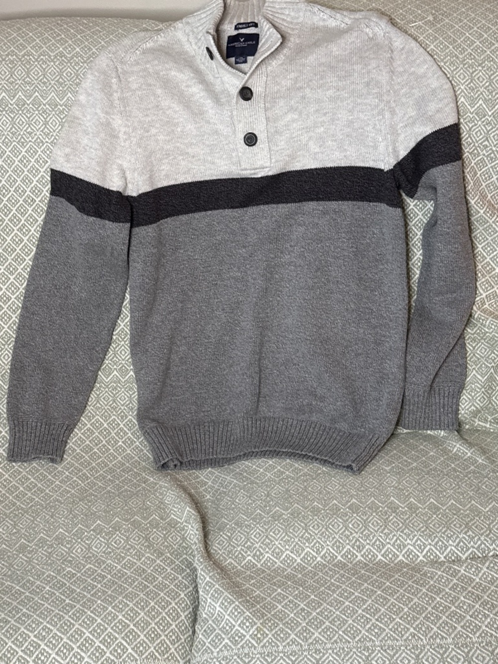 This appears to be an American Eagle Outfitters colorblock henley sweater featur